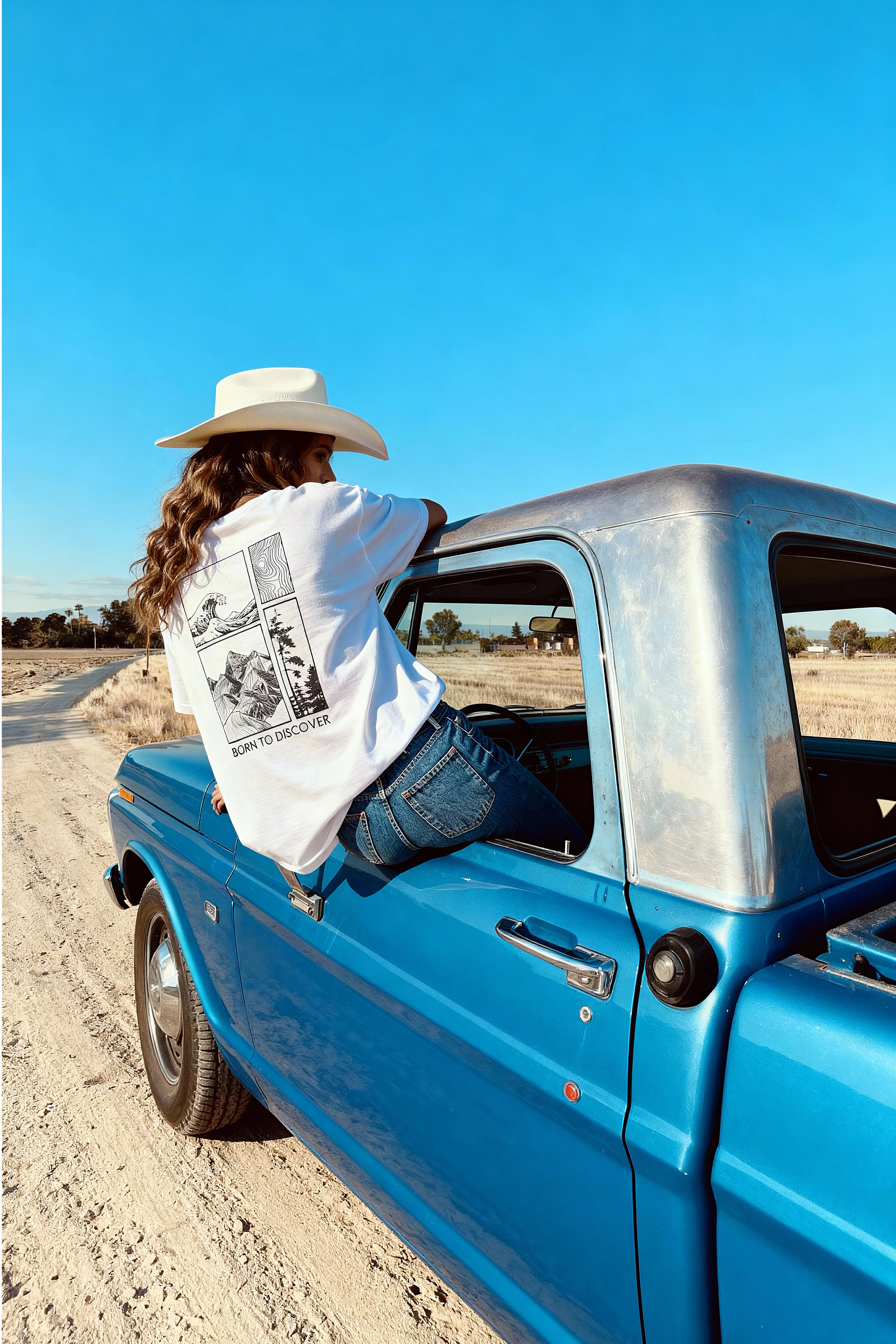 woman in a car wearing relaxed fit white t-shirt
