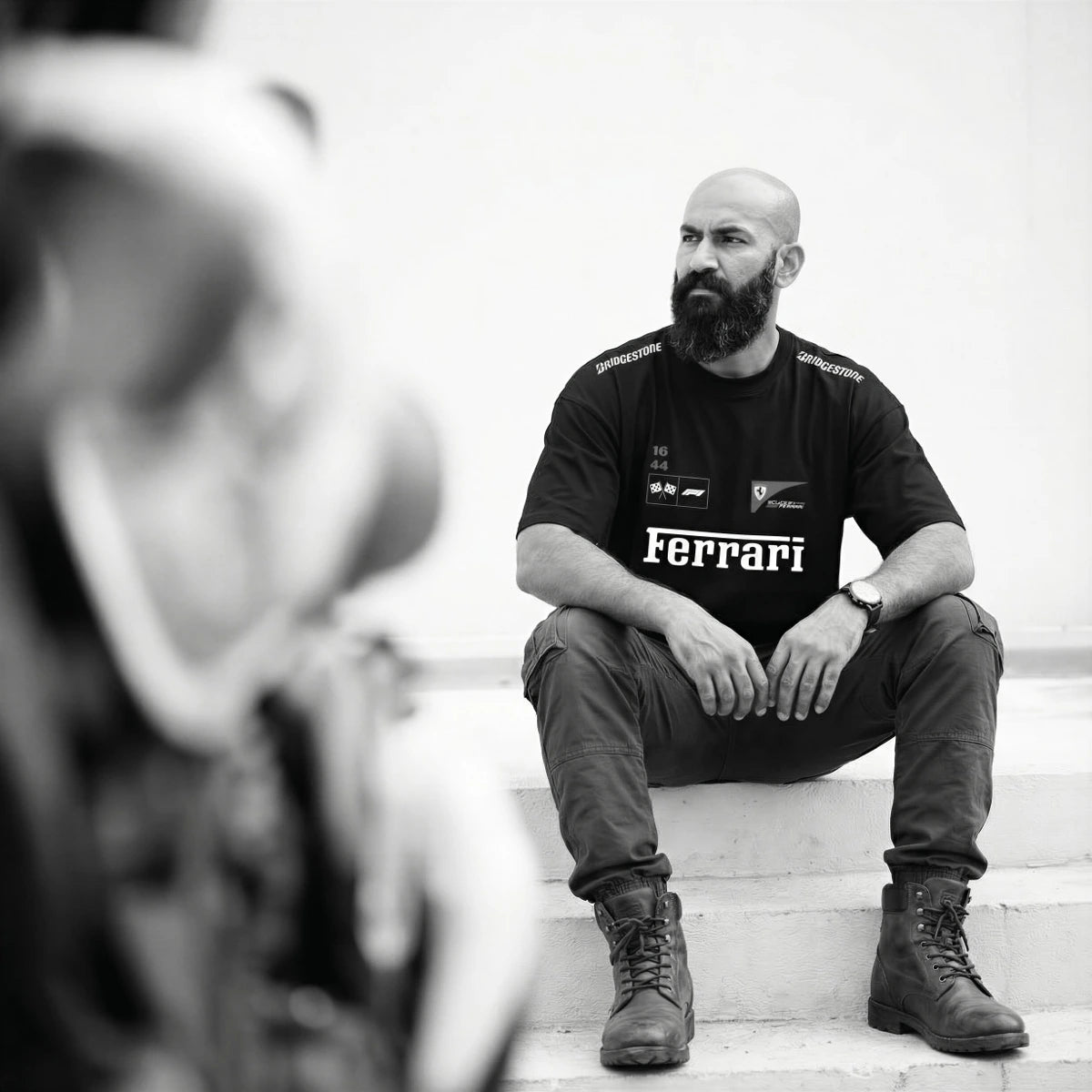 man sitting in black oversized t-shirt