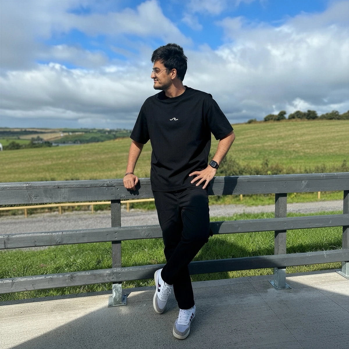 a man wearing black relaxed fit t-shirt